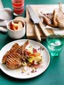 Grilled pork cutlets with peach-chicory salad