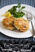 Two Salmon and Dill Fish Cakes on a Plate; Fork