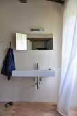 Minimalist bathroom with designer sink and mirror