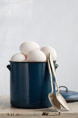White chicken's eggs in an enamel pot