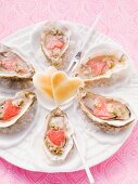 Fresh oysters on a plate of sea salt with heart-shaped toast