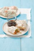 Rice paper rolls with salmon salad and soy sauce (Asia)