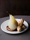 Poached pears with chocolate sauce and puff pastry cakes