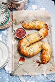 Snake-shaped puff pastry filled with a minced meat filling