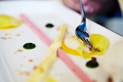 A dessert platter with various fruit sauces