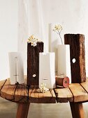 Various white vases and blocks of wood on rustic footstool
