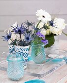 Centrepiece with gerberas, roses, violas and sea-holly