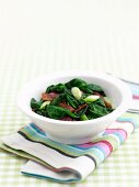 Spinach with bacon and spring onions