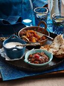 Indian side dishes: wholemeal roti, mango chutney, mint raita, tamarind and date chutney