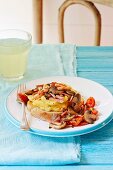 Scrambled eggs with mushrooms and cherry tomatoes on bread