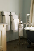 Bathroom with antique bathtub, silver, floor-mounted tap fittings and towel rail