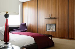 Designer bedroom with Italian furnishings and gas fire integrated into fitted wardrobe