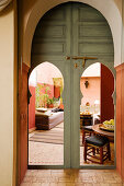 View through open doors with pointed arches into Moroccan living room