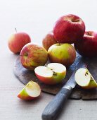 Apples on a board, chopped and whole