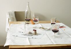 Red wine, bread, salt and pepper on a table after a meal