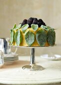 An orange and basil cake topped with blackberries