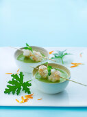 Herb soup with scampi kebabs
