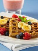 Pecan nut waffles with bananas, blueberries, raspberries and maple syrup