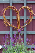 Wicker heart on trellis in garden