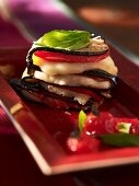 Tomato and aubergine towers with cheese and basil