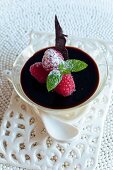 Bavarian cream with chocolate sauce and raspberries