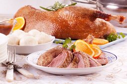 Roast goose with dumplings and oranges