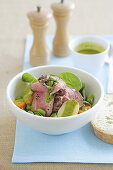 Warm beef salad with spinach and herb dressing