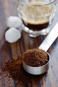 Coffee powder and a glass of espresso