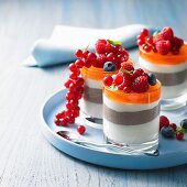 A layered dessert with jelly and fresh berries