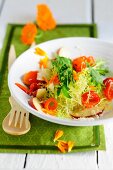Frisee salad with peppers, marigold and peaches