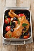 Roast duck leg with dried plums and apples