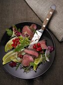 Venison fillet with lettuce and redcurrants