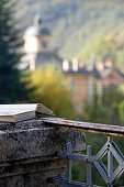 Book lying on weathered stone pillar of roof terrace