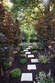 Stepping stone flags leading to garden pond