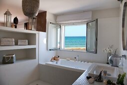 Modern bathroom with open window and sea view