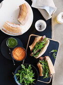 Grilled sausages with a duo of sauces and rocket on bread