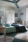 Rustic bedroom with white wardrobe and blue and white-painted wooden floor