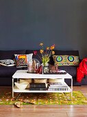 Sitting area in the living room in a mix of styles with sofa, decorative pillows, patterned carpet and coffee table