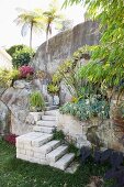 Steps made of stone blocks in Mediterranean garden with palm trees