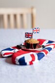 A muffin decorated with Union Jacks on an oven gove