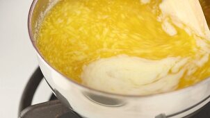 Foaming butter simmering in a pot