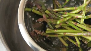 Green asparagus being drained