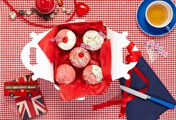 Cupcakes with Union Jacks in a box and a cup of tea