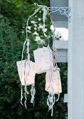 Mobile made of paper-bag lanterns as garden decoration