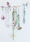 Wall hanging made from old cutlery decorated with paper, fabric and washi tape