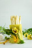 Peeled white asparagus wrapped in a tea towel