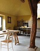 Kitchen-dining room with yellow walls and wooden column