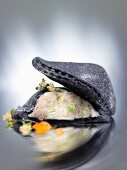 Black ravioli filled with mussel ragout