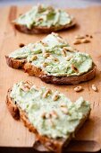 Slices of bread topped with a ramson spread and pine nuts