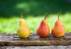 Three pears on a wooden board